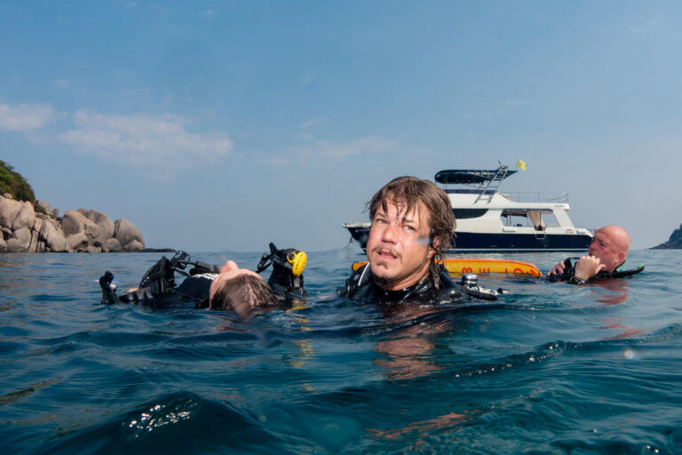 a group of people in scuba gear in water
