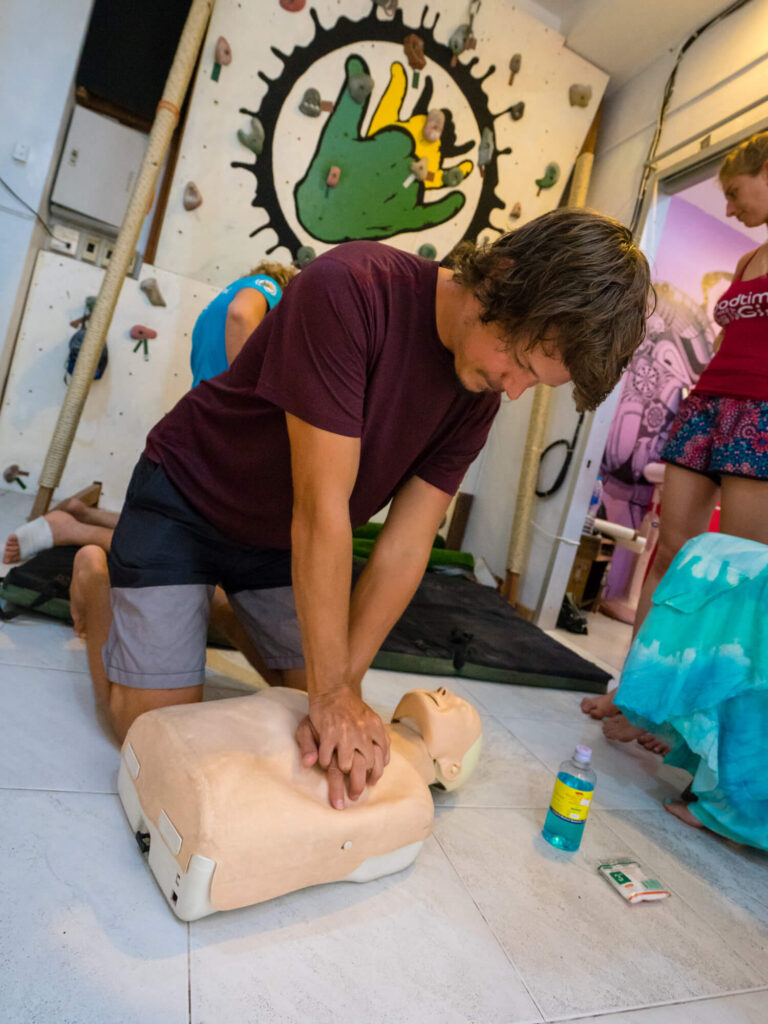 a man practicing cpr on a mannequin