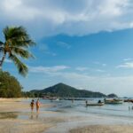 Two women walking on Sairee Beach, Koh Tao, Thailand
