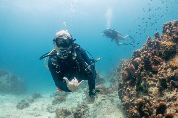 Take the SSI Advanced Adventurer Course here on Koh Tao (equivalent to the PADI Advanced Open Water). Thi picture shows a couple of divers taking the SSI Advanced Adventurer course swimming through one of Koh Taos best dive sites.